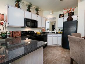Derby apartment for rent - a kitchen with black appliances and granite counter tops