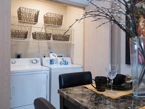 Grandview apartment for rent - a laundry room with a washer and dryer and a counter with a sink
