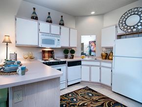 Shawnee apartment for rent - spacious kitchen with white cabinets and appliances and a large counter top