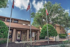 San Antonio apartment for rent - a building with two flags in front of it