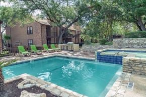 San Antonio apartment for rent - a pool with green chairs around it and a house in the background