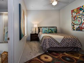 Bentonville apartment for rent - a bedroom with a bed and a ceiling fan
