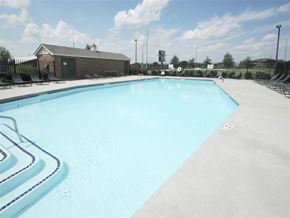 Bentonville apartment for rent - a large swimming pool with chairs around it
