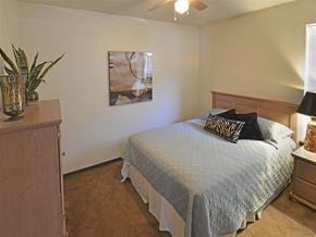 Joplin apartment for rent - a bedroom with a bed and a ceiling fan