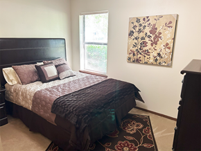 Rogers apartment for rent - a bedroom with a bed and a painting on the wall