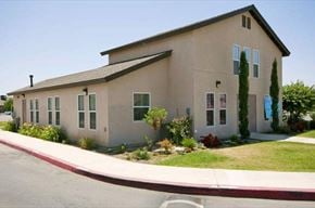 Shafter apartment for rent - a beige house with a yard and a street