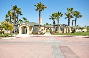 Delano apartment for rent - a house with a driveway and palm trees