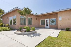 Bakersfield apartment for rent - a building with a driveway and a tree in front of it