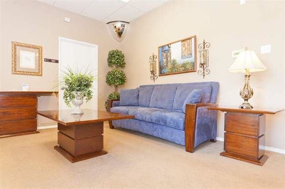 Bakersfield apartment for rent - a living room with a blue couch and a table