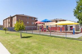 Bakersfield apartment for rent - a yard with a playground and some buildings