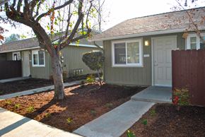 Fresno apartment for rent - the front of a house with a sidewalk and a tree