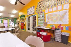 El Mirage apartment for rent - a classroom with tables and chairs and a map on the wall
