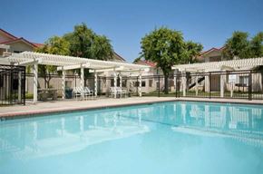 Porterville apartment for rent - a large swimming pool with a fence around it