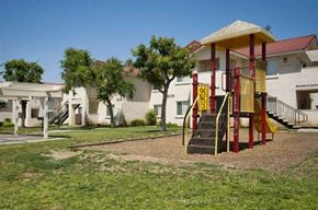 Porterville apartment for rent - a yellow and red swing set in a playground