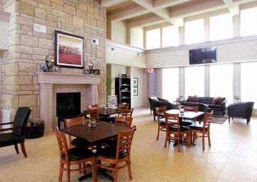 Houston apartment for rent - a living room with tables and chairs and a fireplace