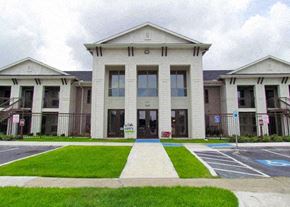 Houston apartment for rent - the front of a building with a sidewalk and grass