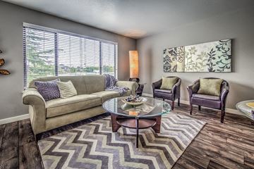 Boise multi-family for rent - a living room with a couch and chairs and a table