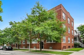 Chicago apartment for rent - a red brick building with trees in front of it