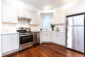 San Francisco apartment for rent - a kitchen with stainless steel appliances and white cabinets