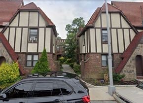 Flushing apartment for rent - a car parked in a driveway in front of two houses