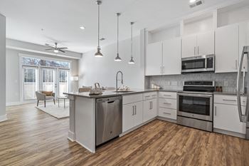 Well appointed kitchens with double stacked cabinets and large under mount sinks