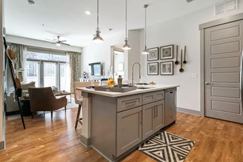Well appointed kitchens with double stacked cabinets and large under mount sinks