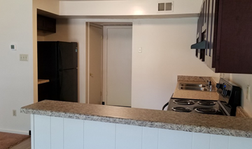 Lexington townhouse for rent - a kitchen with a counter and a stove and a refrigerator