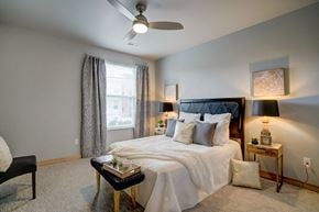 Madison apartment for rent - a bedroom with a bed and a ceiling fan
