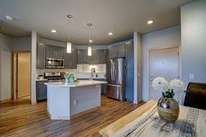 Madison apartment for rent - a kitchen with a center island and a stainless steel refrigerator
