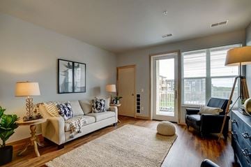 Madison apartment for rent - a living room with a couch and a door to a balcony