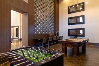 Game salon with billiards, foosball, refreshment bar and multiple flat screen tvs