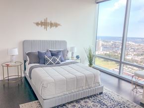Baltimore apartment for rent - a bedroom with a bed and a view of the city
