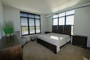 Plymouth apartment for rent - A bedroom with a large bed and a couch.