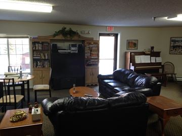 Fergus Falls apartment for rent - a living room with leather couches and a table and a television