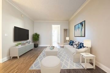 Pasadena apartment for rent - A living room with a white couch and a television on the wall.