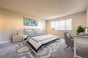 Pasadena apartment for rent - A bedroom with a large bed and a desk with a chair.