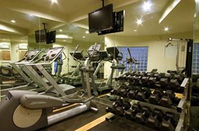 Burbank apartment for rent - a gym with a lot of weights and a tv