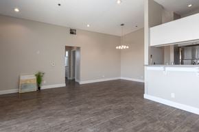 North Hollywood apartment for rent - the living room and kitchen of an empty house with a wood floor