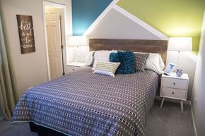Bloomingdale apartment for rent - a bedroom with a bed with pillows and a night stand