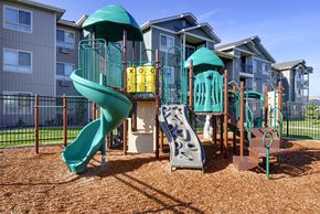 Lacey apartment for rent - Playground with grass by apt buildings 110 Copper Wood LN SE Lacey Washington 98516 Copper Wood Apts For Rent