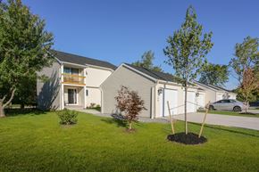 Amherst townhouse for rent - the exterior of a white house with a yard and a tree
