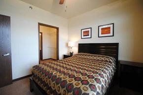 Stanley apartment for rent - a bedroom with a large bed and a mirror