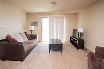 Stanley apartment for rent - a living room with a couch and a table
