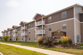 Stanley apartment for rent - an exterior view of an apartment building with a sign for stamen trail apartments