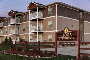 Tioga apartment for rent - a building with a sign in front of it