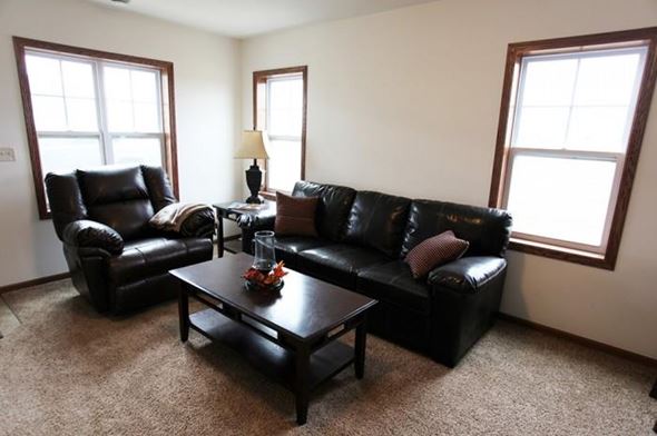 Tioga townhouse for rent - a living room with leather couches and a coffee table