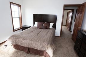 Tioga townhouse for rent - a bedroom with a bed and a wooden headboard