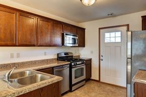 Tioga townhouse for rent - a kitchen with a sink a stove and a refrigerator