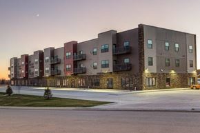 Tioga apartment for rent - a building with a lot of windows and a street