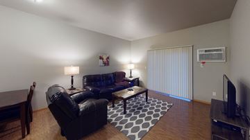 Williston apartment for rent - a living room with leather furniture and a tv
